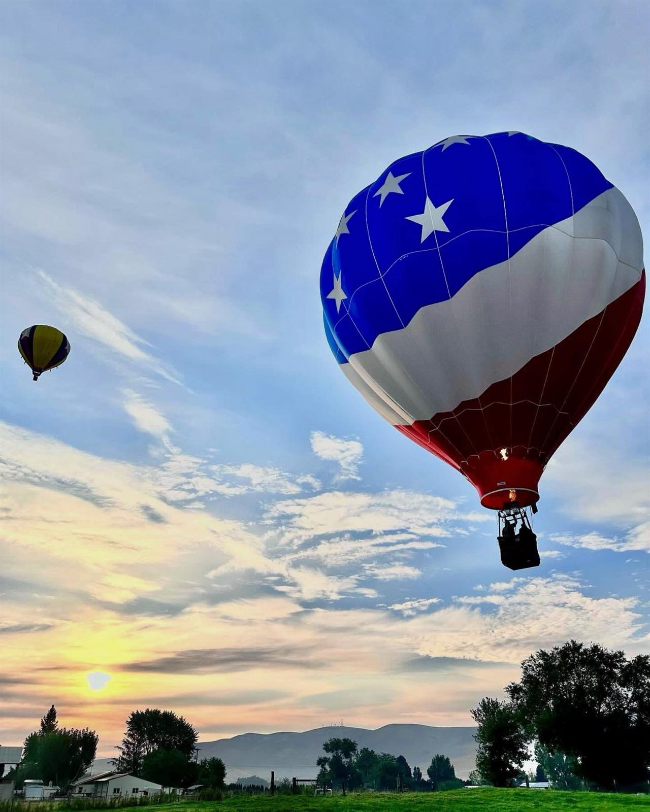 Flag balloon aloft at sunrise